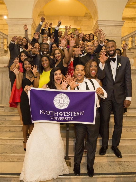 Carter wedding picture holding a Northwestern University banner